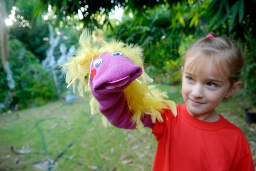 Child (6 years old) showing her red handmade hand puppet.